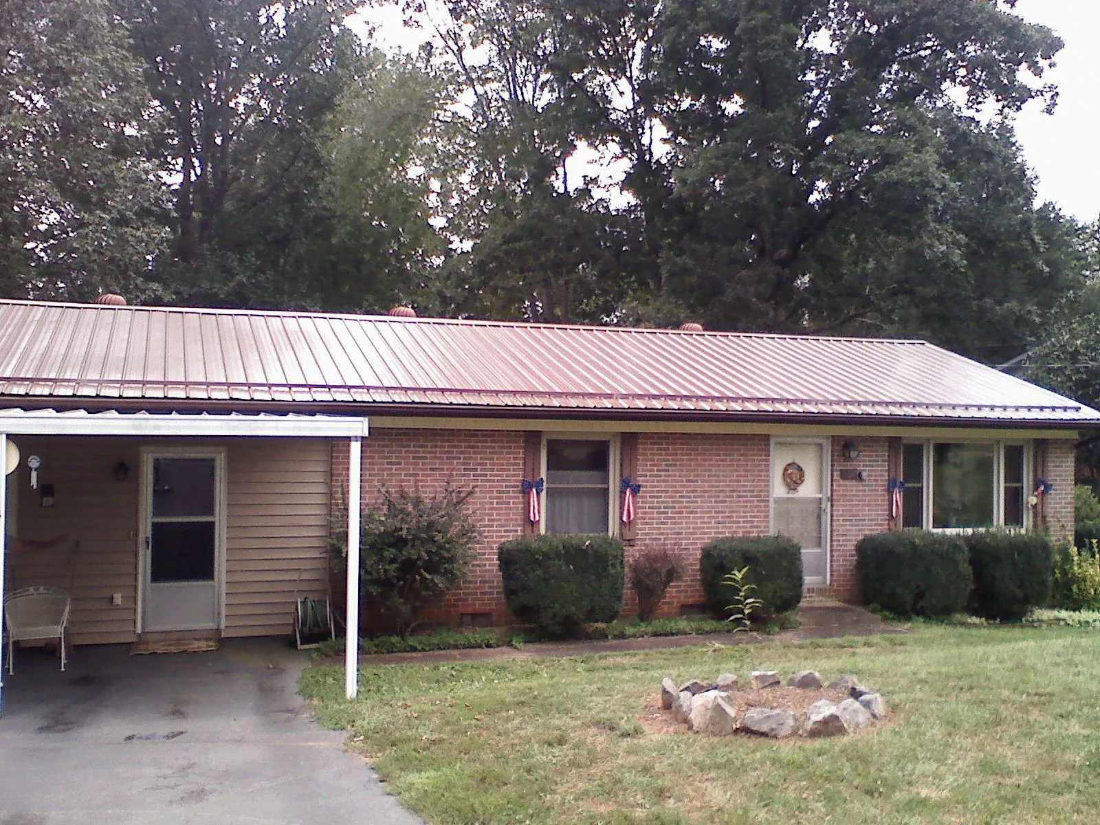 Bronze metal roof and carport on a brick ranch home — Roof Repair work by our crew in Ft Mitchell