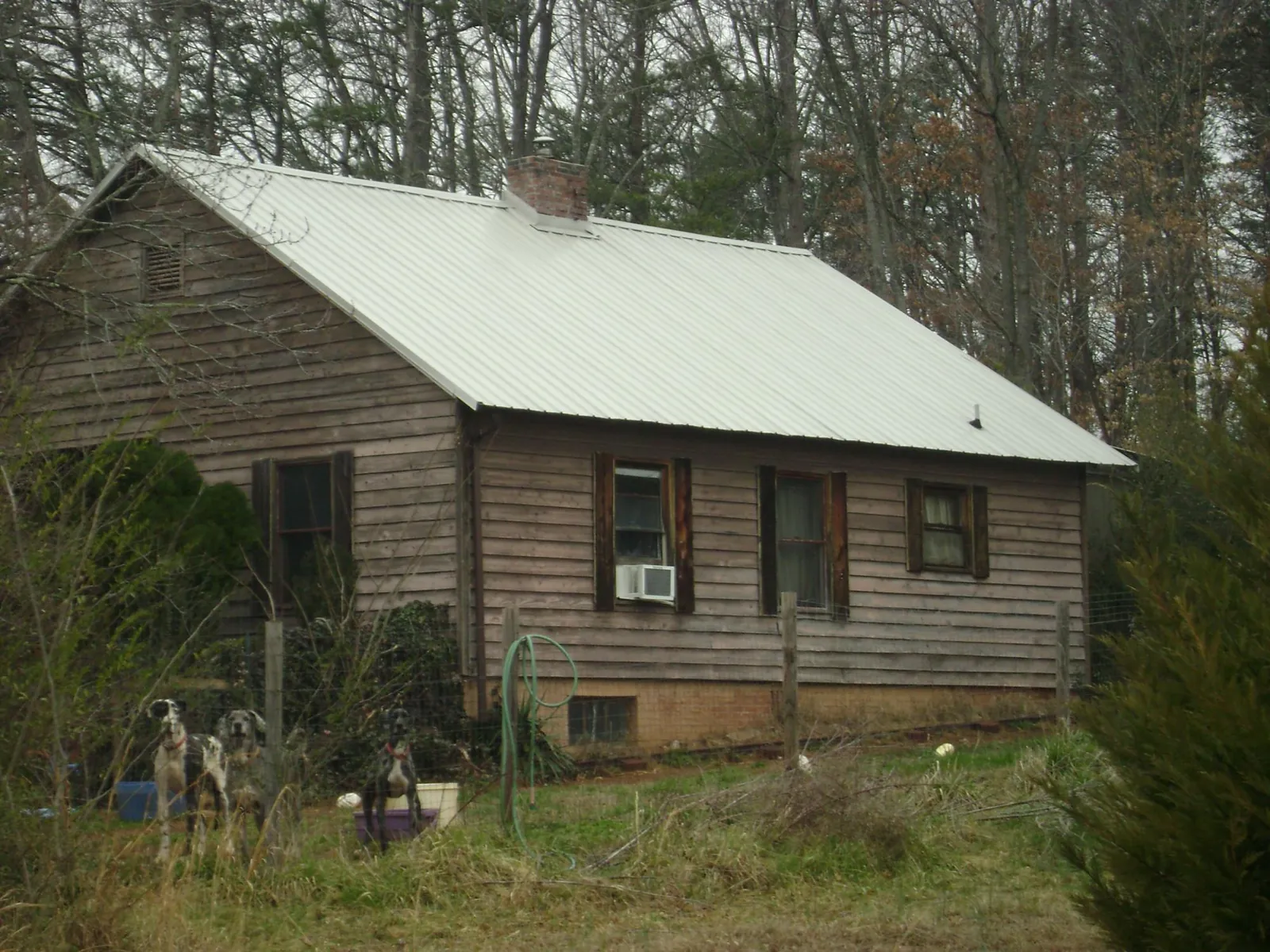 White metal roof on an old wood sided farmhouse, from a Metal Roof Installation job in Ft Mitchell